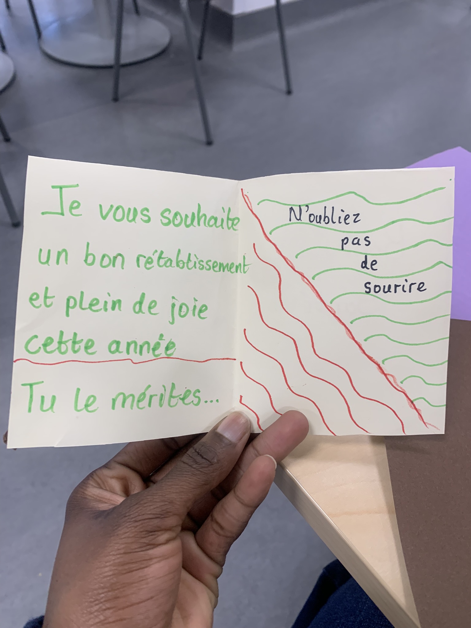 Collection of handmade greeting cards in various colors including yellow, pink, and brown scattered on table