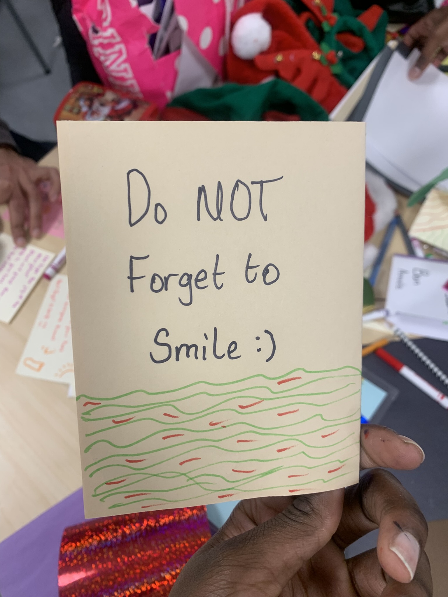 White card with black text and colorful wave pattern reading 'Do NOT Forget to Smile :)'